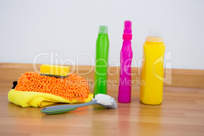 Chemical bottles by brush and sponges on floor
