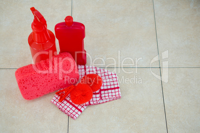 High angle view of red cleaning products with napkin
