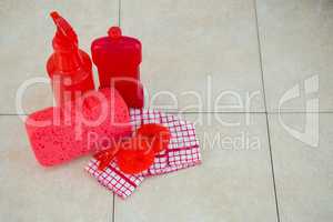 High angle view of red cleaning products with napkin