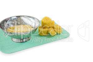 Close up of pasta in colander with tagliolini on place mat