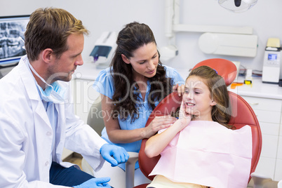 Young patient showing teeth to dentist