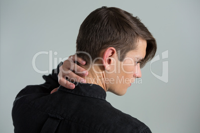 Androgynous man touching his neck