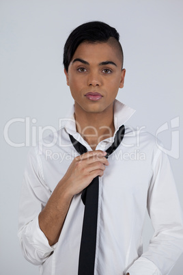 Portrait of transgender female holding tie