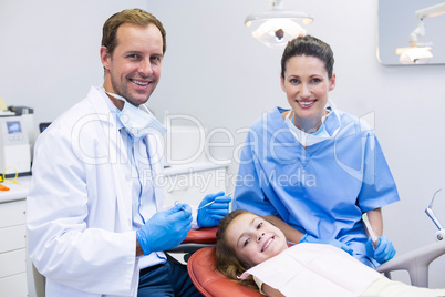 Portrait of smiling dentists and young patient