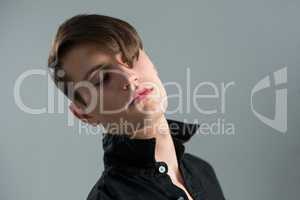 Androgynous man posing with eyes closed