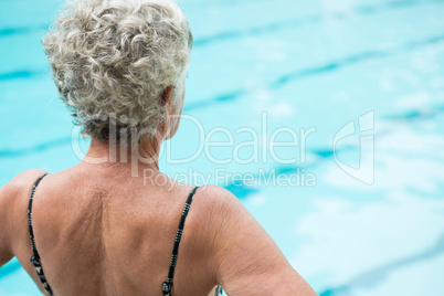 Senior woman looking at swimming pool