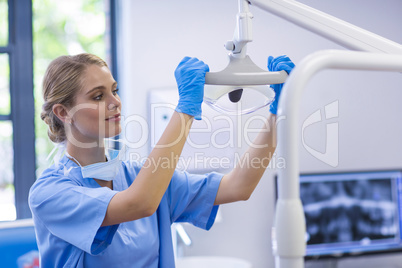 Female nurse adjusting dental light
