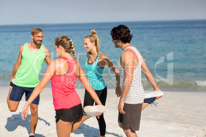 Friends exercising at beach