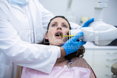 Dentist taking x-ray of patients teeth