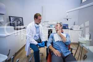 Dentist talking to male patient