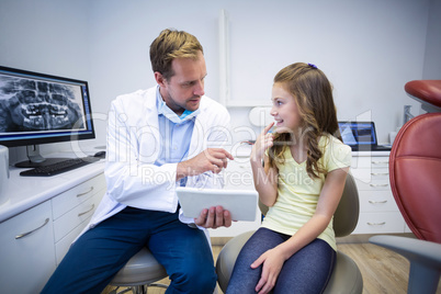 Young patient showing teeth to dentist