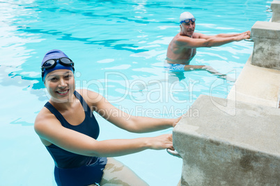 Smiling senior man and woman at poolside