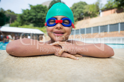 Smiling boy leaning on poolside