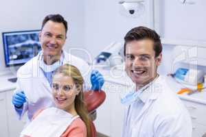 Portrait of smiling dentists and female patient