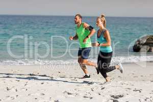 Young couple jogging at beach