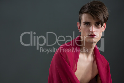 Androgynous man wrapped in red clothes