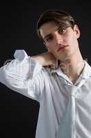 Androgynous man posing with hands on his head