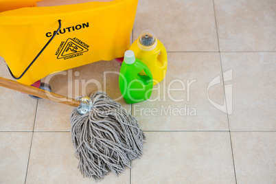 High angle view of bottles by mop bucket