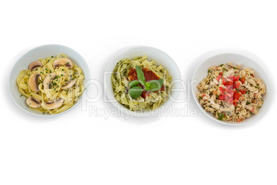 Overhead view of pastas served in containers