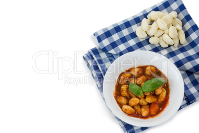 Overhead view of gnocchi pasta in bowl on napkin