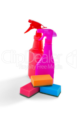 Colorful spray bottles and cleaning sponges