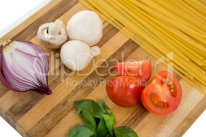 High angle of vegetable and spaghetti on cutting board