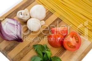 High angle of vegetable and spaghetti on cutting board
