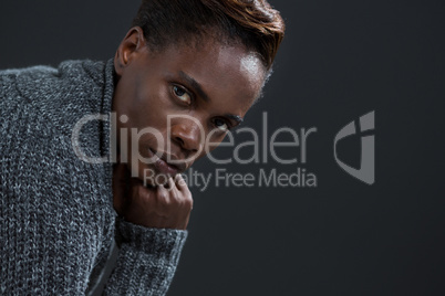 Androgynous man posing with hand on his chin