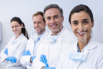 Smiling dentists standing with arms crossed