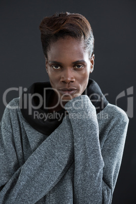 Androgynous man posing with hand on his chin