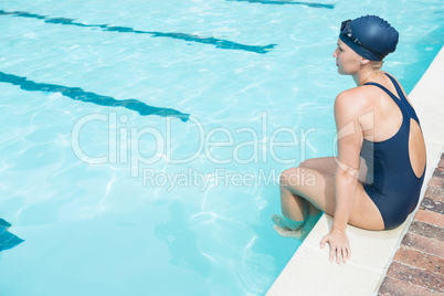 Thoughtful woman relaxing at poolside