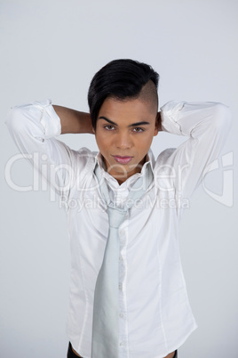 Confident transgender woman with hands behind head