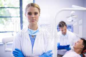 Portrait of dentist standing with arms crossed