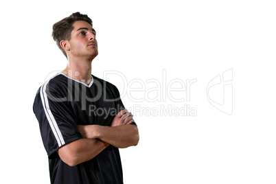 Football player standing with arms crossed