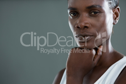Androgynous man posing with hand on chin