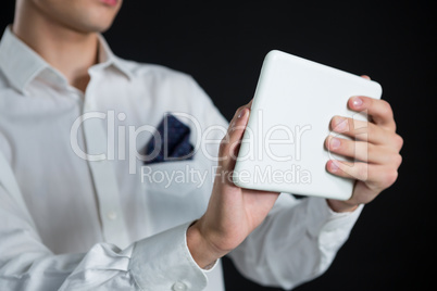 Androgynous man using digital tablet