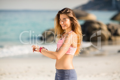 Beautiful woman smiling while standing at beach