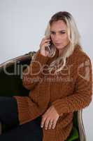 Transgender woman using mobile phone while sitting on chair