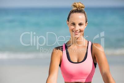 Beautiful woman smiling while sitting at beach
