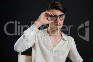 Androgynous man posing with spectacles