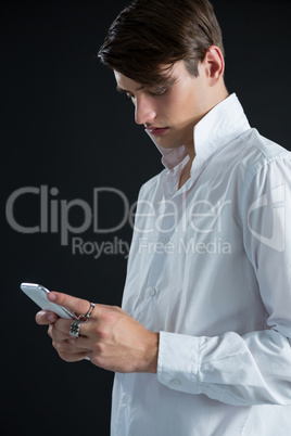 Androgynous man using mobile phone