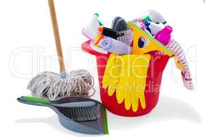 Mop and dustpan by cleaning products in bucket