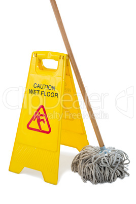 Close up of wet floor sigh board with mop