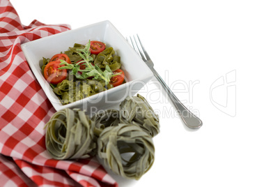 High angle view of pasta in bowl by napkin