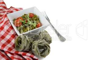 High angle view of pasta in bowl by napkin