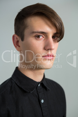 Androgynous man looking at camera