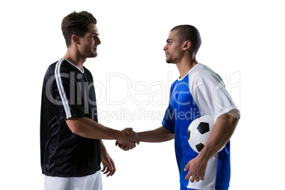 Two football players shaking hands