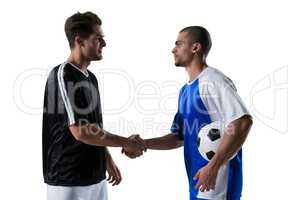 Two football players shaking hands
