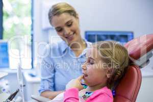 Young patient looking in the mirror at dental clinic