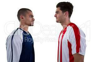 Two rival football player looking at each other
